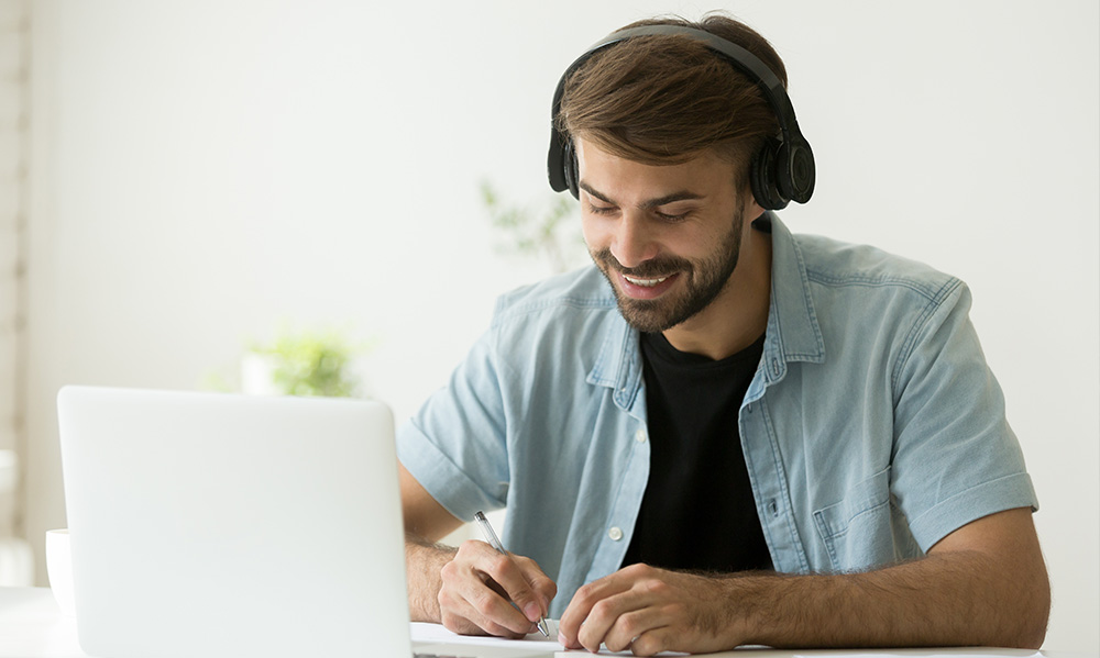 man with laptop and headphones