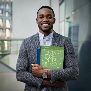 employee holding a training guide on leveraging neurodiversity in the workplace