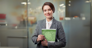Image of a female employee holding a leveraging neurodiversity training guide.
