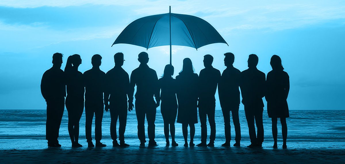 group of business people under an umbrella representing psychological safety in the workplace