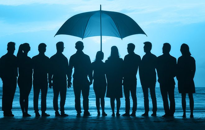 group of business people under an umbrella representing psychological safety in the workplace